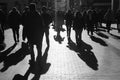 People walking on the street. Urban crowd in backlight