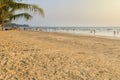 People stroll the beach, sea and sand in the evening during the summer holidays Royalty Free Stock Photo