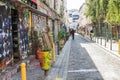 People stroll down brick paved alley lined with colorful graffiti in Belleville, Paris, France Royalty Free Stock Photo