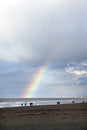 People stroll on north sea beach in holland with cloudy sky and Royalty Free Stock Photo