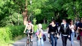 People stroll, run and ride bicycles in the public park