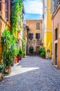 people are strollin through narrow street of trastevere district in italian capital rome, which ic local center of