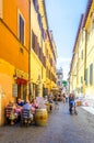 people are strollin through narrow street of trastevere district in italian capital rome, which ic local center of