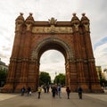 People are strolling through an alley between the arch of triumph and Ciutadella park Barcelona, Spain, 2020
