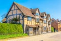 People are strolling next to the birth house of William Shakespeare in Stratford upon Avon, England