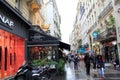 People strolling through the rain, holding umbrellas, near famous restaurant, L'Escargot, Paris, France, 2016 Royalty Free Stock Photo