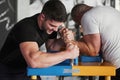 People is struggling to win. Arm wrestling challenge between two men. Match on a special table Royalty Free Stock Photo