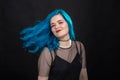 People, style and fashion concept - Close up portrait of young woman with blue long hair dressed in black dress Royalty Free Stock Photo