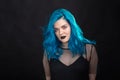 People, style and fashion concept - Close up portrait of young woman with blue long hair dressed in black dress Royalty Free Stock Photo