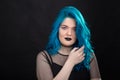 People, style and fashion concept - Close up portrait of young woman with blue long hair dressed in black dress Royalty Free Stock Photo