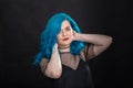 People, style and fashion concept - Close up portrait of young woman with blue long hair dressed in black dress Royalty Free Stock Photo