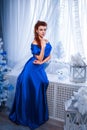 People, style, holidays, hairstyle and fashion concept - happy young woman or teen girl in blue dress