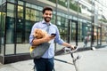 People, style, technology, leisure and lifestyle concept. Happy young man with smartphone on city street