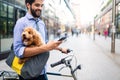 People, style, technology, leisure and lifestyle concept. Happy young man with smartphone on city street