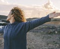 People and successful moment. Woman portrait overjoyed and excited outstretching and opening arms outdoor in leisure happy