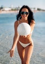 woman in bikini playing with volleyball on beach Royalty Free Stock Photo