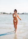 smiling young woman in bikini swimsuit on beach Royalty Free Stock Photo