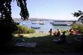 People sunbathe and enjoy by the Zurich lake. many boats and yachts on water. Clear blue city lake on summer Royalty Free Stock Photo