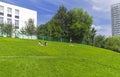 People sunbathe on the grassy hillside. Moscow
