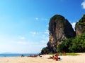 People sunbathing on beautiful Railay beach under the cliffs in south Thailand