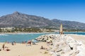 People sunbathing on Levante beach Puerto BanÃÂºs Spain