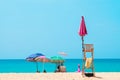 People sunbathing and relaxing on beach chairs. Sea view and blue sky.