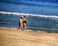 People sunbathing and relaxing in a Sunny day on the beach Royalty Free Stock Photo