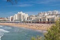 People sunbathing in scenic seascape of atlantic ocean in blue sky in surf spot destination of biarritz, france