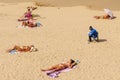 People sunbathing on the beach in Gijon Spain