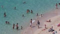 People sunbathing and swimming in Portals Nous beach in Mallorca detail