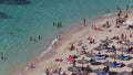 People sunbathing and swimming in Portals Nous beach in Mallorca wide