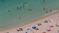 People sunbathing and swimming in Portals Nous beach in Mallorca wide