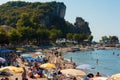 People sunbathing walking or swimming in a very crowded day in Amasra beach