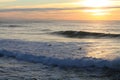 People surfing huge waves in colorful sunset in atlantic ocean, capbreton, france Royalty Free Stock Photo