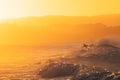 People surfing in the sea during sunset. Vibrant orange colors with copy space Royalty Free Stock Photo