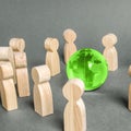 People surrounded a green Globe world planet earth. Cooperation and collaboration of people around the world. Outsourcing Royalty Free Stock Photo