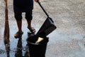 People are sweeping dirty water at ground streets, cleaner floor, housemaid, housekeeper, homemaker, maidservant, maid Royalty Free Stock Photo