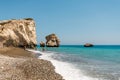 People swim at the beach next to a popular Aphrodite Rock in Cyprus