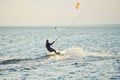 People swim in the sea on a kiteboard