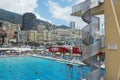 People swim and sunbathe at the open air public swimming pool in Monaco.