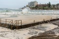 People swiming despite a mass of thick foam covered the rock pool following extreme Royalty Free Stock Photo