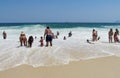 People swiming in the ocean waves at Copacabana beach