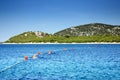 People swimming with buoys in a clean, warm sea, Croatia Dalmatia