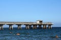 People swimming in front of a pier in Fort Lauderdale