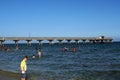 People swimming in front of a pier in Fort Lauderdale Royalty Free Stock Photo