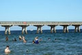 People swimming in front of a pier in Fort Lauderdale Royalty Free Stock Photo