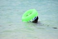 People Swimming With Inflatable Beach Toys