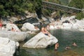 People swimming and sunbathing on maggia river at Ponte Brolla