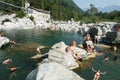 People swimming and sunbathing on maggia river at Ponte Brolla