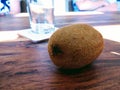 People with table and glass and kiwi fruit. Healthy food.